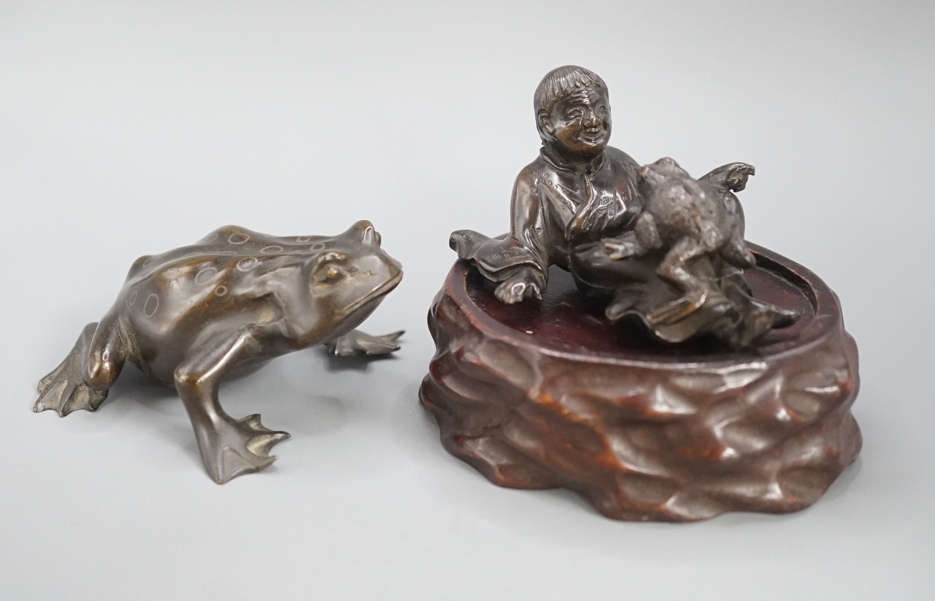 A Chinese bronze group of Liu Hai and a toad, wood stand and a bronze figure of a dog, 9cm